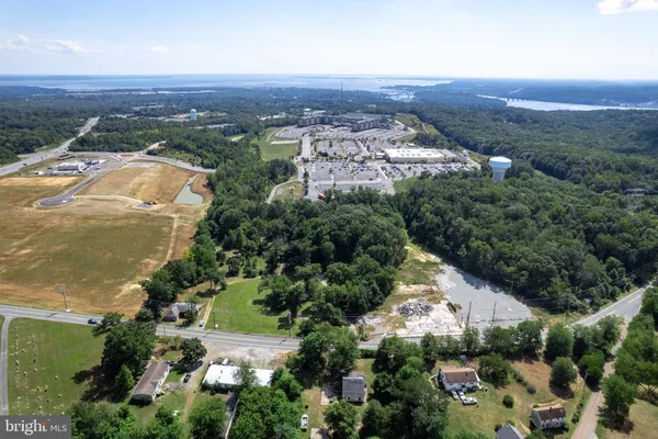 an aerial view of residential houses with outdoor space and trees