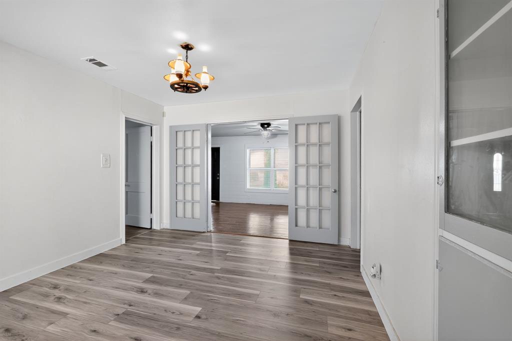 5485 Highway 7 Marlin, TX 76661 - Photo 8 of 36 Spare room with a chandelier and wood finished floors