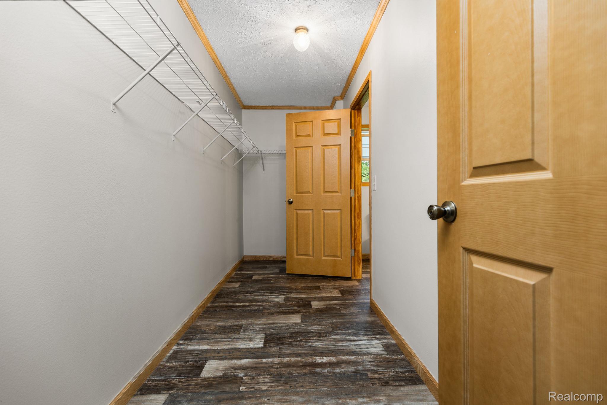 102 Wiard Road Ypsilanti, MI 48198 - Photo 20 of 37 Walk in closet featuring dark wood finished floors