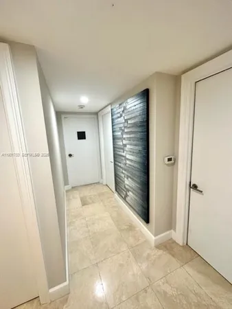 a bathroom with a tub a rug and a glass door shower