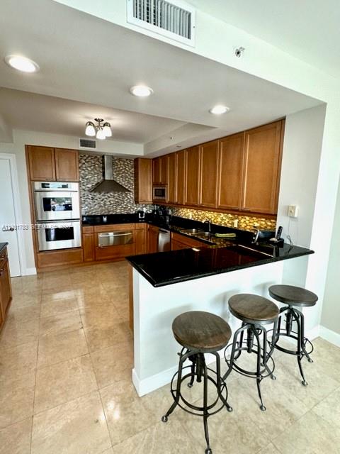 20201 East Country Club Drive, Unit 903 Aventura, FL 33180 - Photo 21 of 61 a kitchen with stainless steel appliances kitchen island granite countertop a sink and cabinets