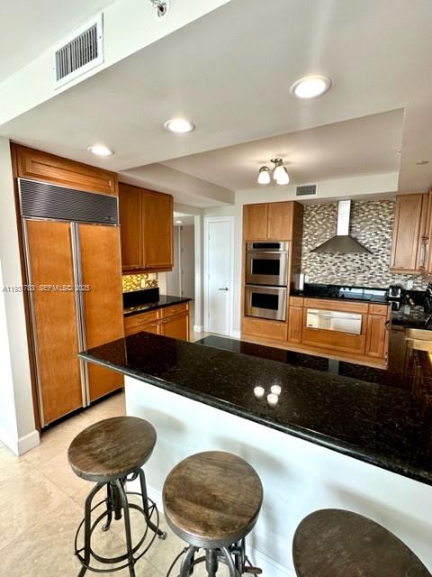 20201 East Country Club Drive, Unit 903 Aventura, FL 33180 - Photo 22 of 61 a kitchen with stainless steel appliances a dining table and chair