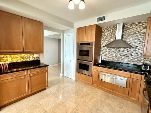 20201 East Country Club Drive, Unit 903 Aventura, FL 33180 - Photo 24 of 61 a kitchen with granite countertop a stove a sink and a microwave