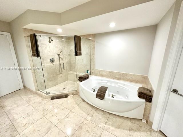 20201 East Country Club Drive, Unit 903 Aventura, FL 33180 - Photo 37 of 61 a bathroom with a tub a rug and a glass door shower