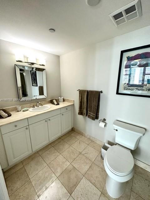 20201 East Country Club Drive, Unit 903 Aventura, FL 33180 - Photo 44 of 61 a bathroom with a toilet sink and mirror
