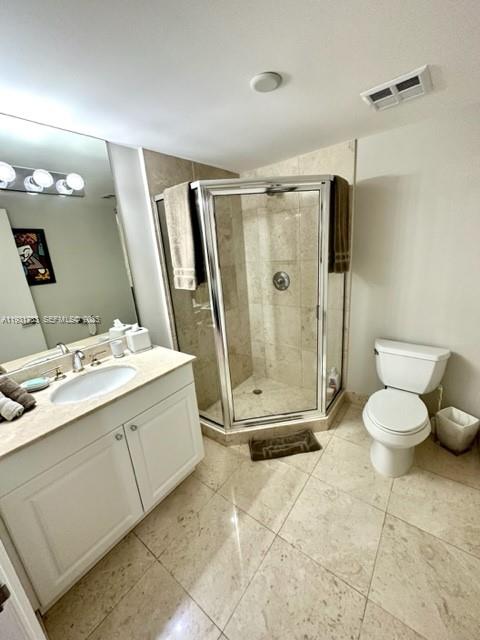 20201 East Country Club Drive, Unit 903 Aventura, FL 33180 - Photo 50 of 61 a bathroom with a double vanity sink toilet and shower
