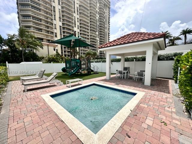 20201 East Country Club Drive, Unit 903 Aventura, FL 33180 - Photo 60 of 61 a view of a chairs and tables in the patio