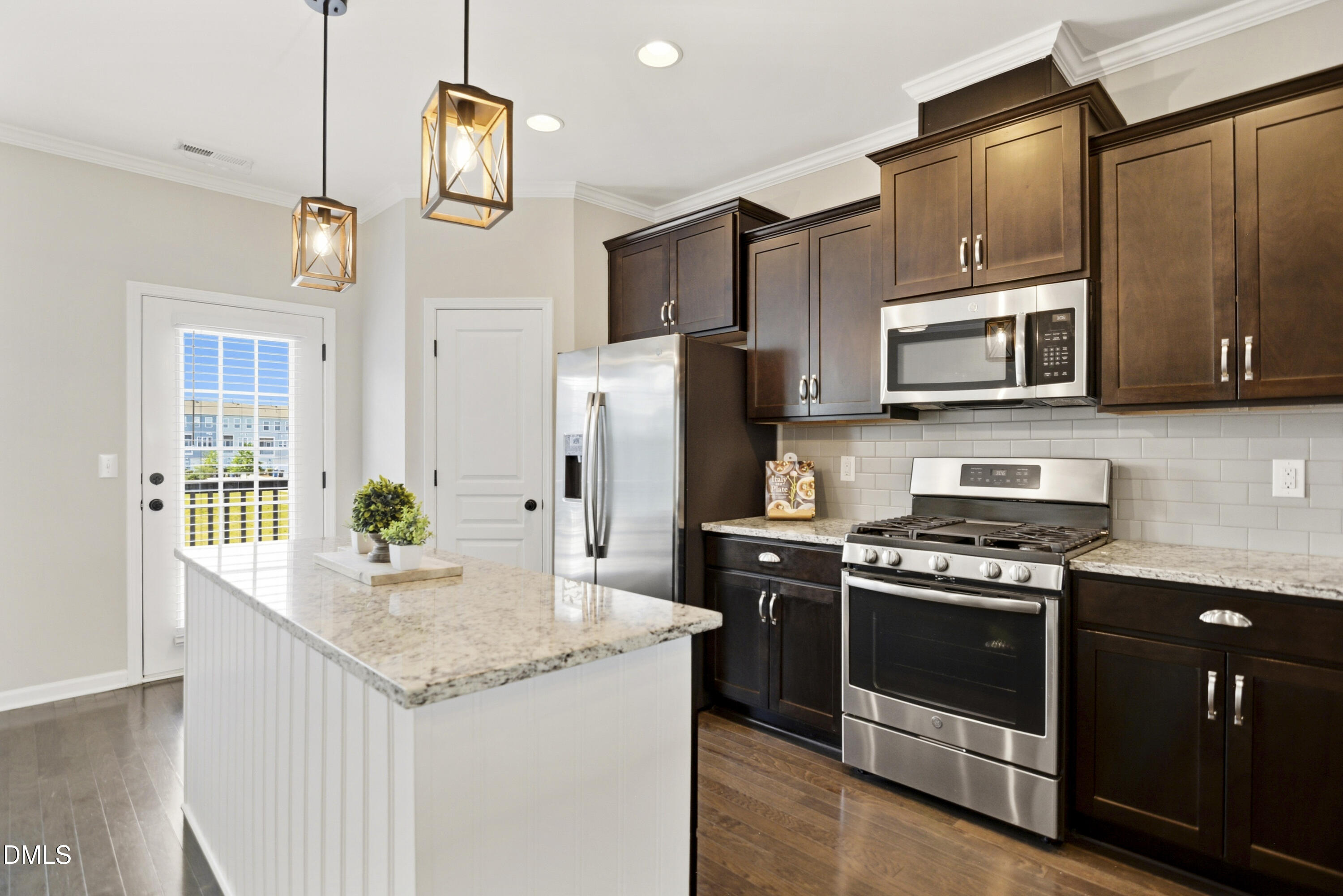 5916 Giddings Street Raleigh, NC 27616 - Photo 9 of 49 a kitchen with stainless steel appliances granite countertop a stove a refrigerator and a microwave