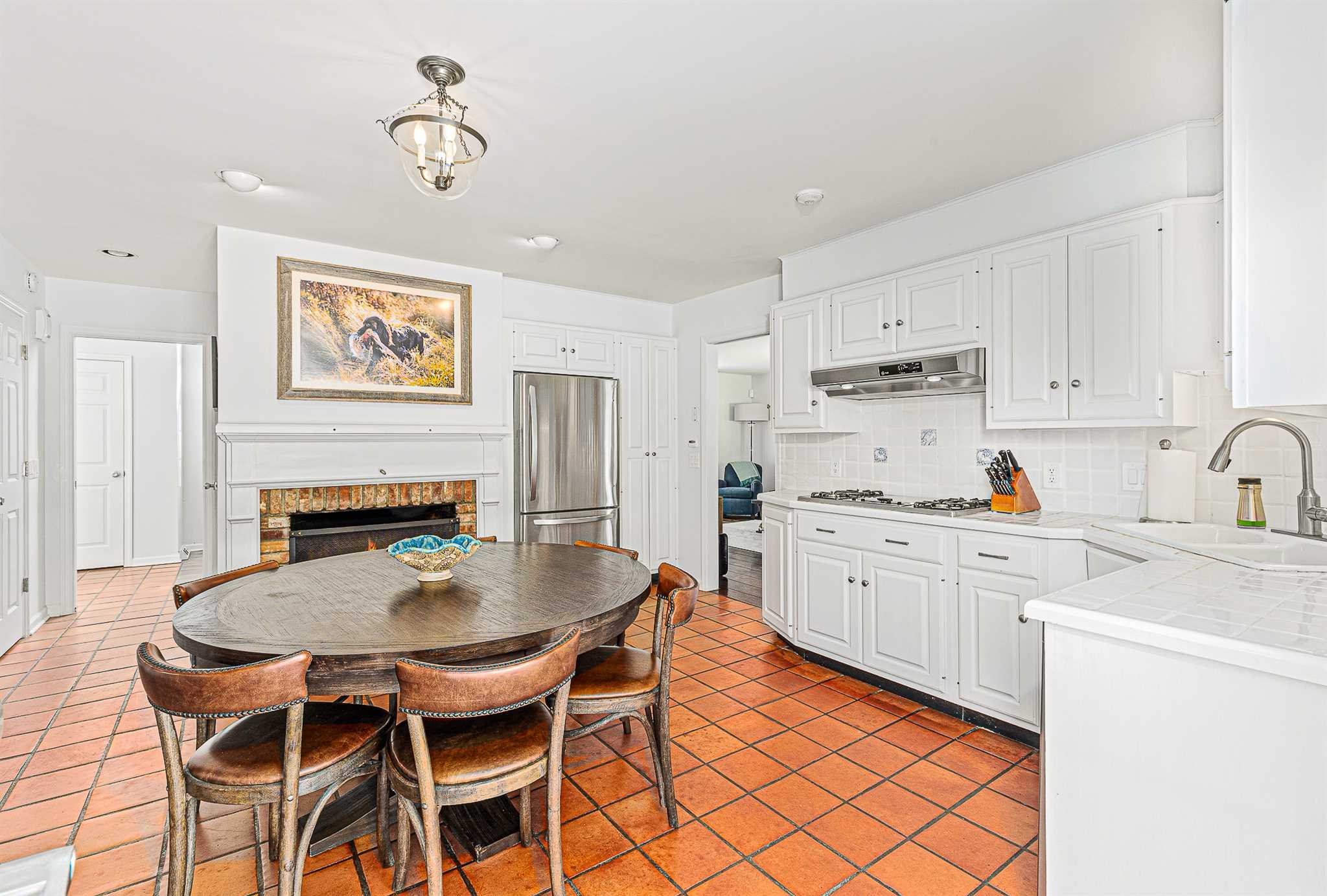49 Linden Lane Millbrook, NY 12545 - Photo 13 of 29 a kitchen with stainless steel appliances granite countertop a stove a sink a dining table and chairs