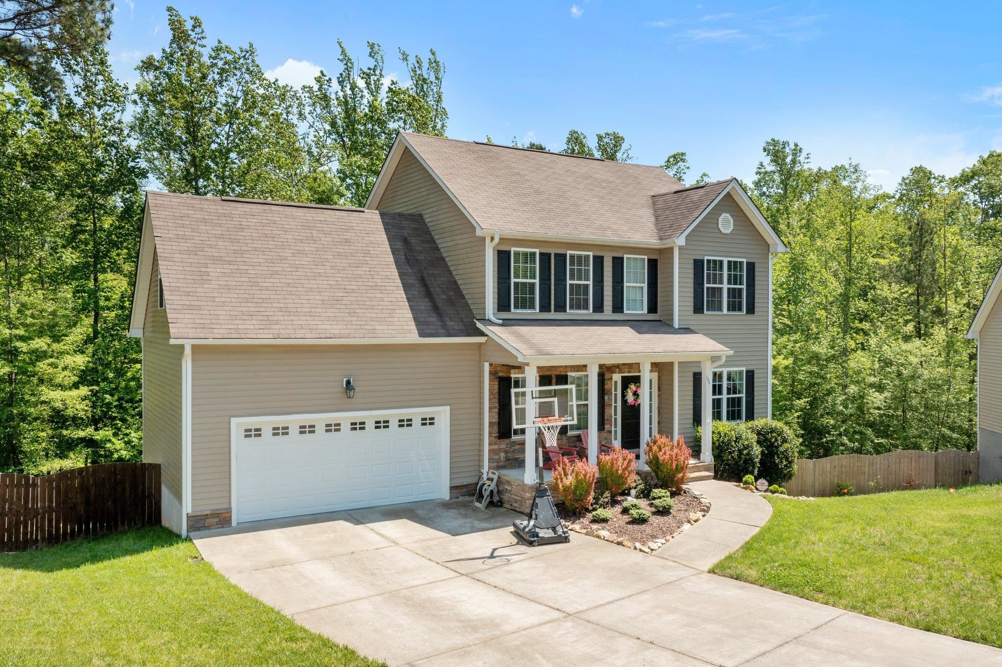 104 Griffis Drive Stem, NC 27581 - Photo 1 of 37 a view of a white house with a yard potted plants and a table