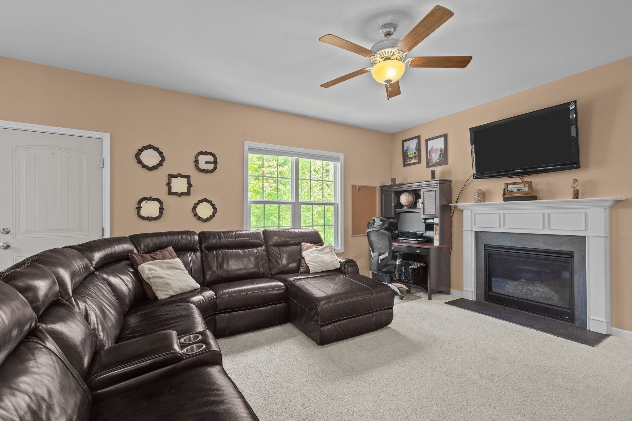 104 Griffis Drive Stem, NC 27581 - Photo 12 of 37 a living room with furniture a flat screen tv and a fireplace