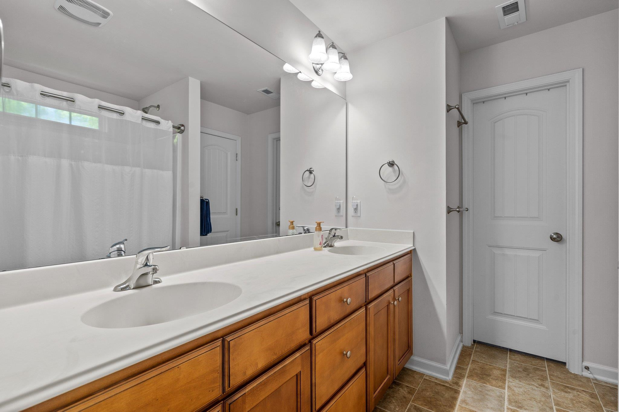 104 Griffis Drive Stem, NC 27581 - Photo 18 of 37 a bathroom with a sink double vanity and a mirror