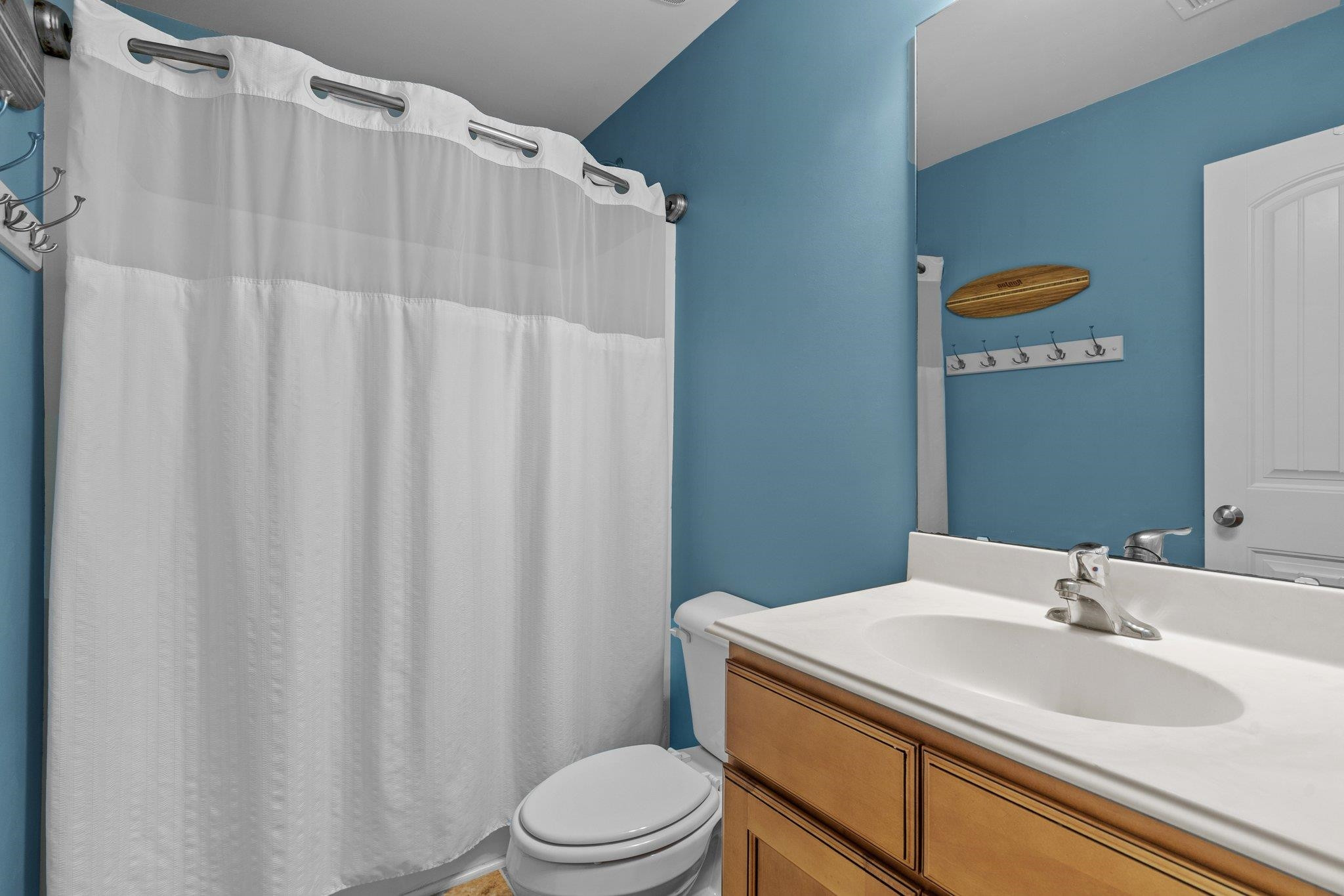 104 Griffis Drive Stem, NC 27581 - Photo 23 of 37 a bathroom with a sink a toilet and shower curtain