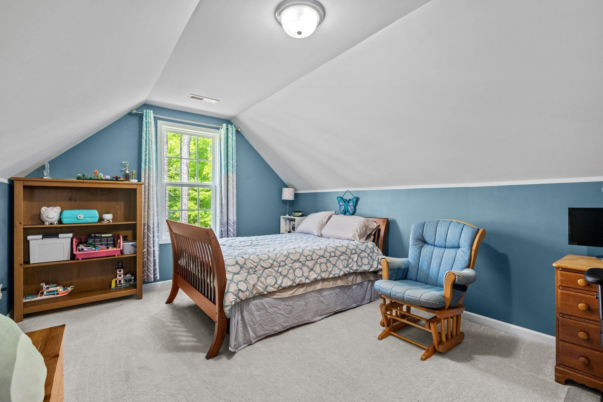 104 Griffis Drive Stem, NC 27581 - Photo 24 of 37 a bedroom with a bed and a chair