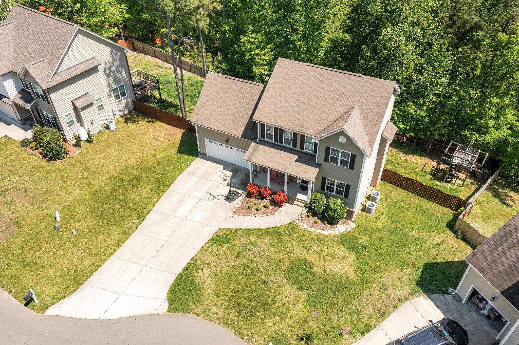 104 Griffis Drive Stem, NC 27581 - Photo 36 of 37 an aerial view of a house with swimming pool and large trees