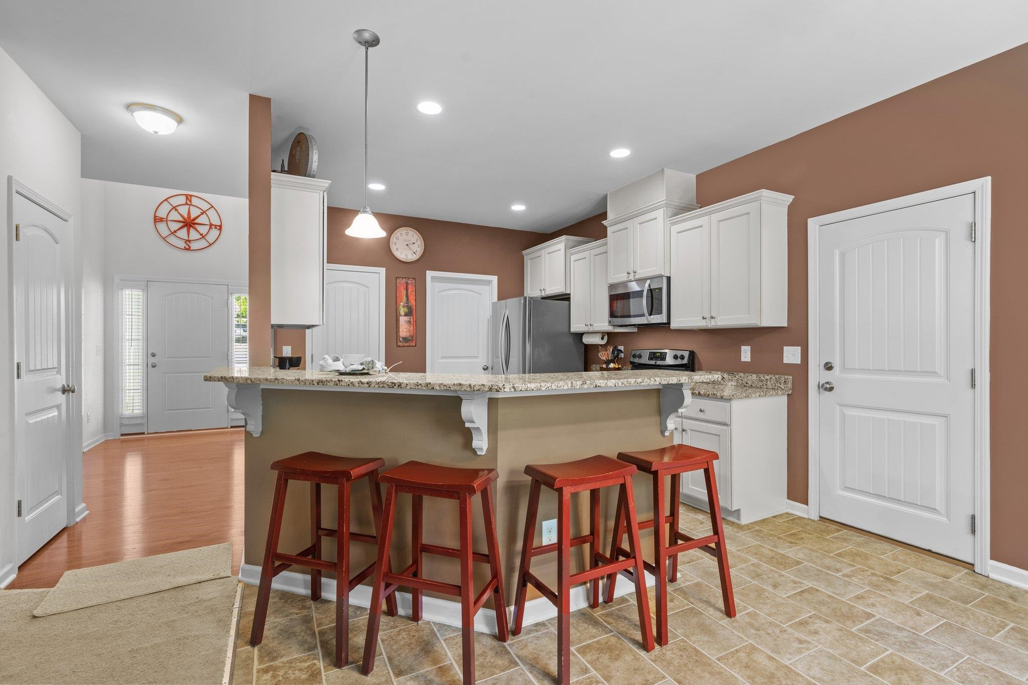 104 Griffis Drive Stem, NC 27581 - Photo 10 of 37 a kitchen with stainless steel appliances granite countertop a table chairs sink and cabinets