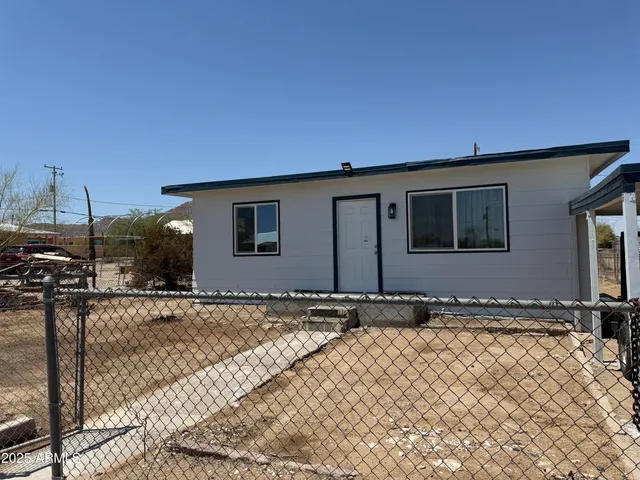 a kitchen with granite countertop a refrigerator and a stove top oven