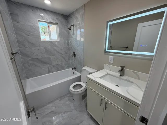 a white toilet sitting next to a bathroom sink