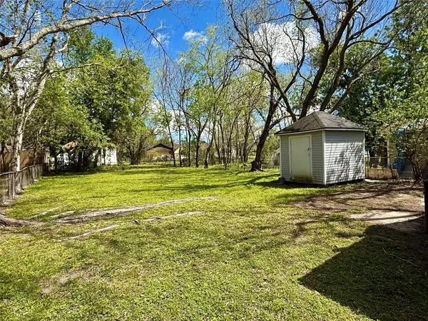 a front view of house with yard and trees