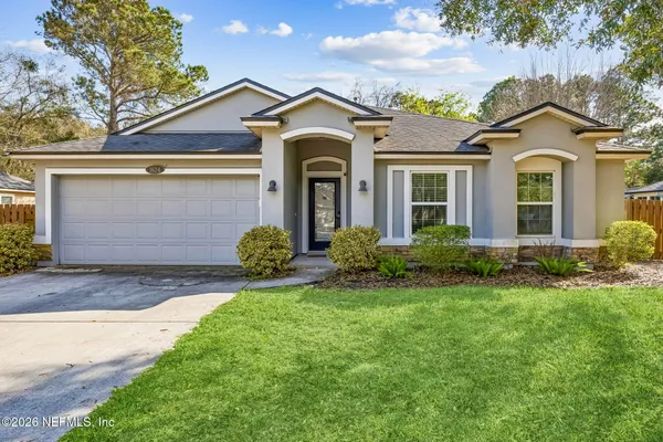 a front view of a house with a yard