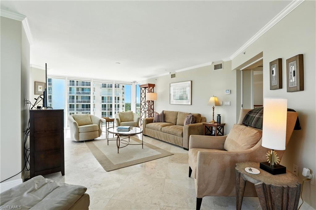 20 Seagate Drive, Unit 803 Naples, FL 34103 - Photo 18 of 40 Living room with crown molding and floor to ceiling windows
