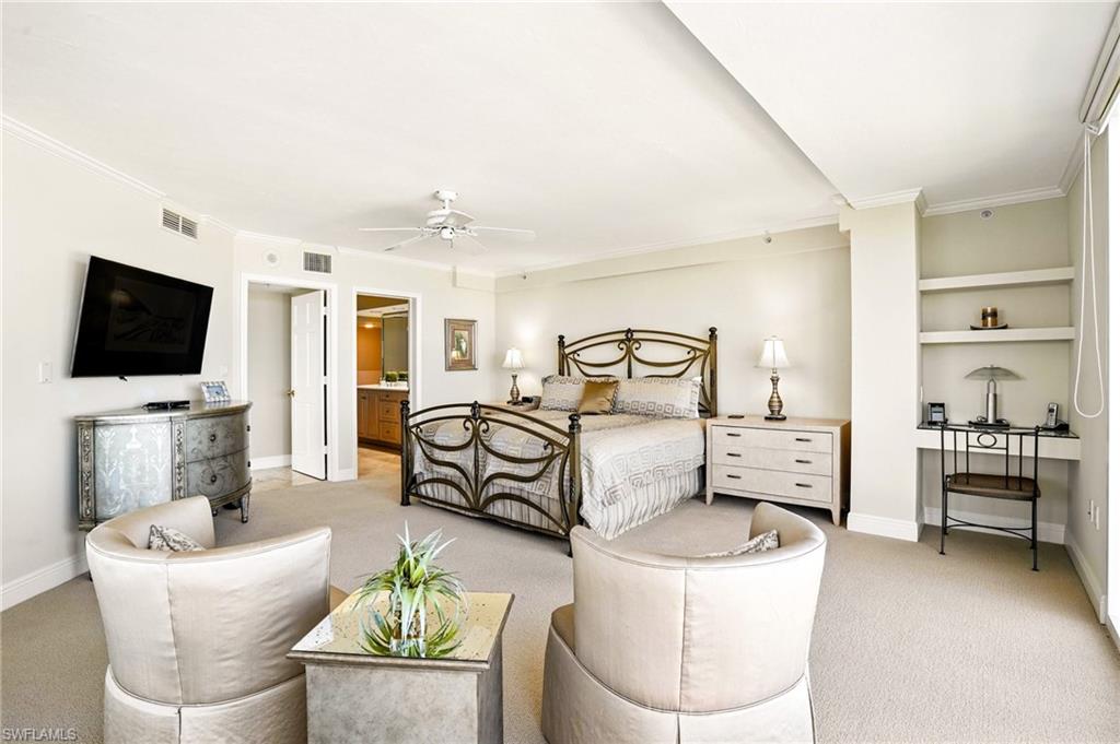 20 Seagate Drive, Unit 803 Naples, FL 34103 - Photo 26 of 40 Bedroom with light carpet, ornamental molding, ensuite bath, and a ceiling fan