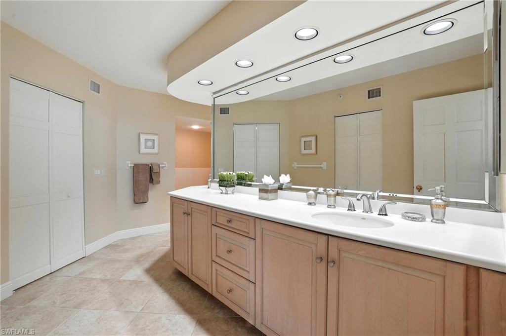 20 Seagate Drive, Unit 803 Naples, FL 34103 - Photo 27 of 40 Full bathroom featuring double vanity, recessed lighting, a closet, and light tile patterned floors