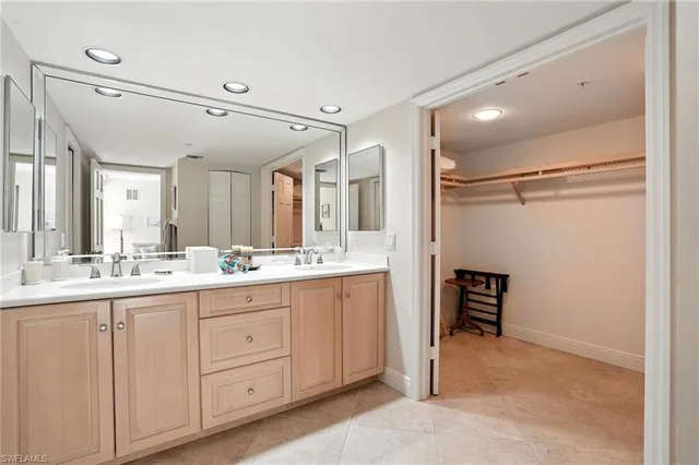 a bathroom with a double vanity sink and mirror