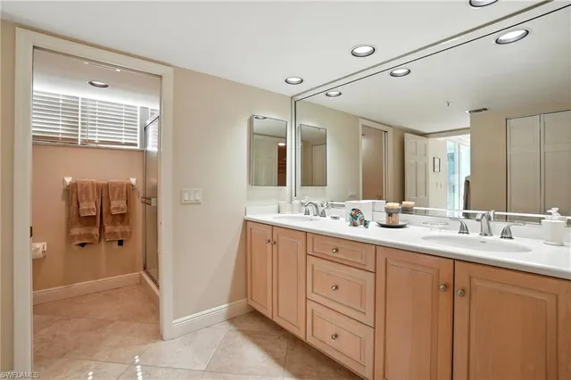 a bathroom with a sink a mirror and a shower