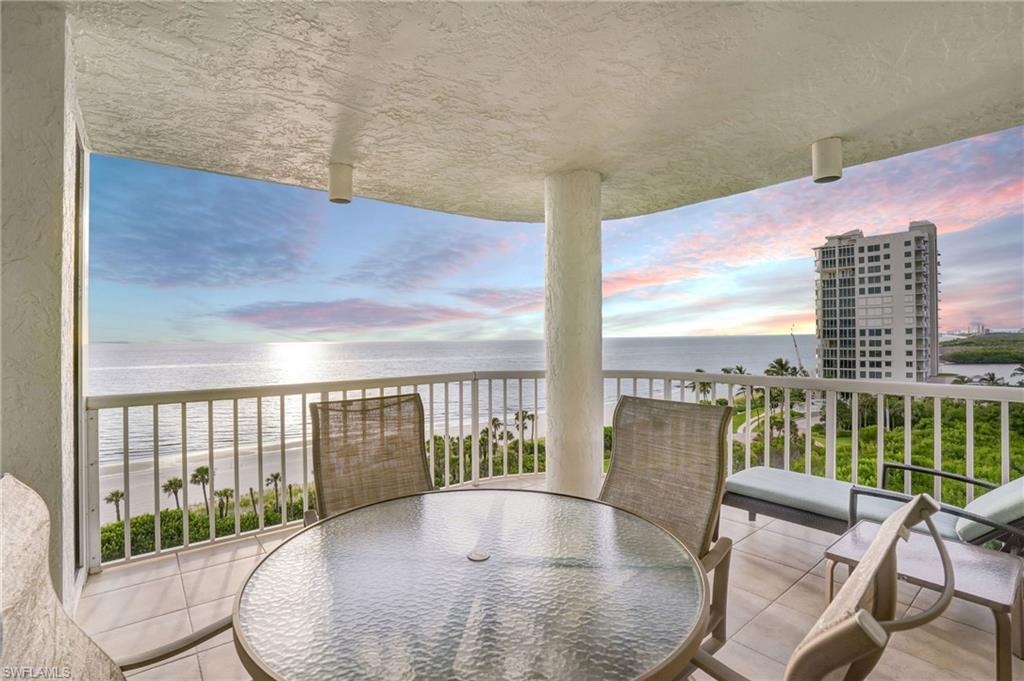 20 Seagate Drive, Unit 803 Naples, FL 34103 - Photo 37 of 40 Balcony featuring view of water and beach and outdoor dining area
