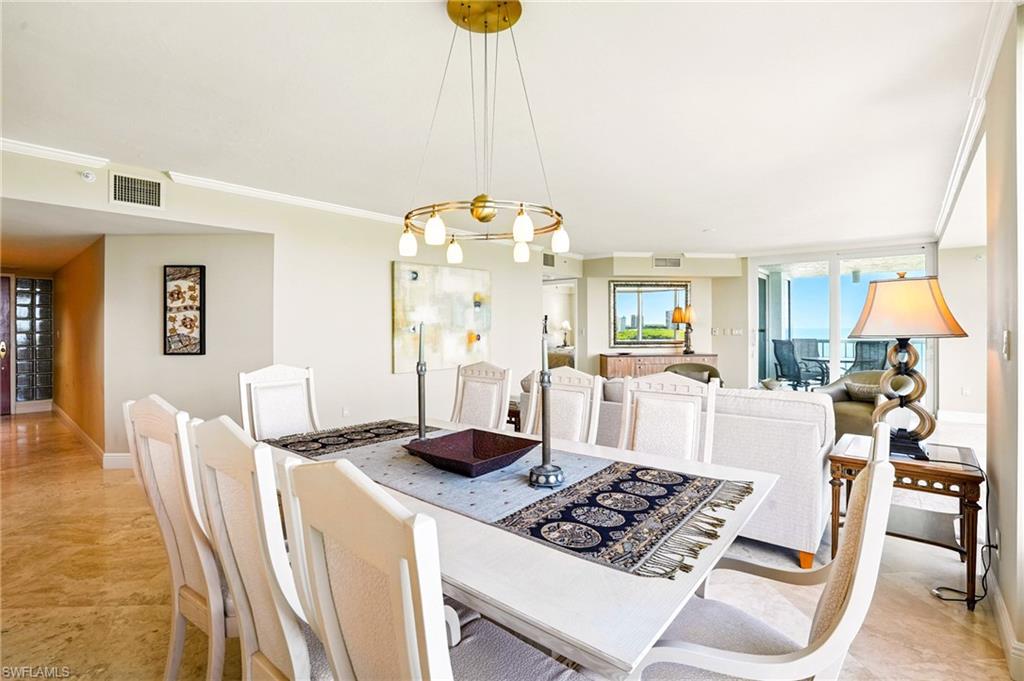 20 Seagate Drive, Unit 803 Naples, FL 34103 - Photo 9 of 40 Dining area featuring crown molding and suspended lighting