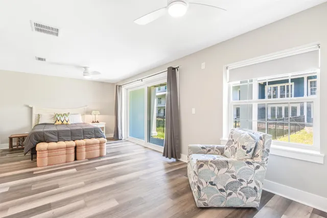 a bedroom with a bed and a large window