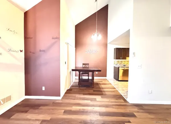 a view of a livingroom with furniture and a kitchen