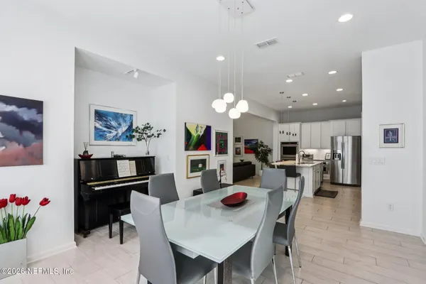 a kitchen with refrigerator cabinets dining table and chairs