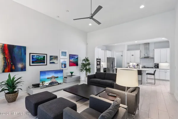 a view of a dining room with furniture and a potted plant