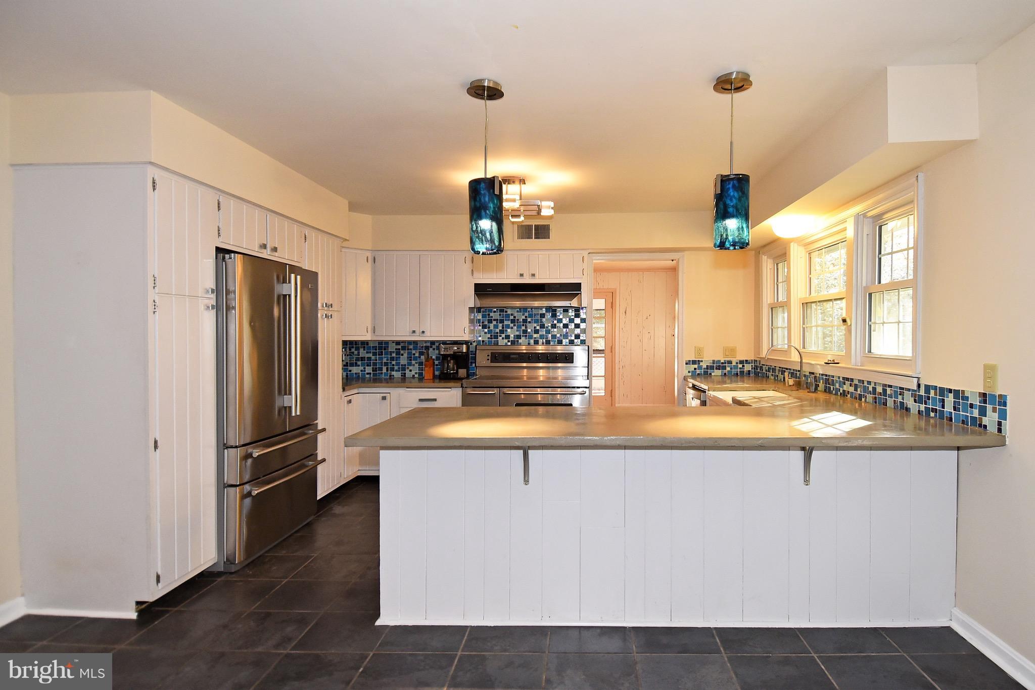 14911 West Auburn Road Accokeek, MD 20607 - Photo 18 of 30 a large kitchen with stainless steel appliances granite countertop a refrigerator a oven and a sink with granite countertops
