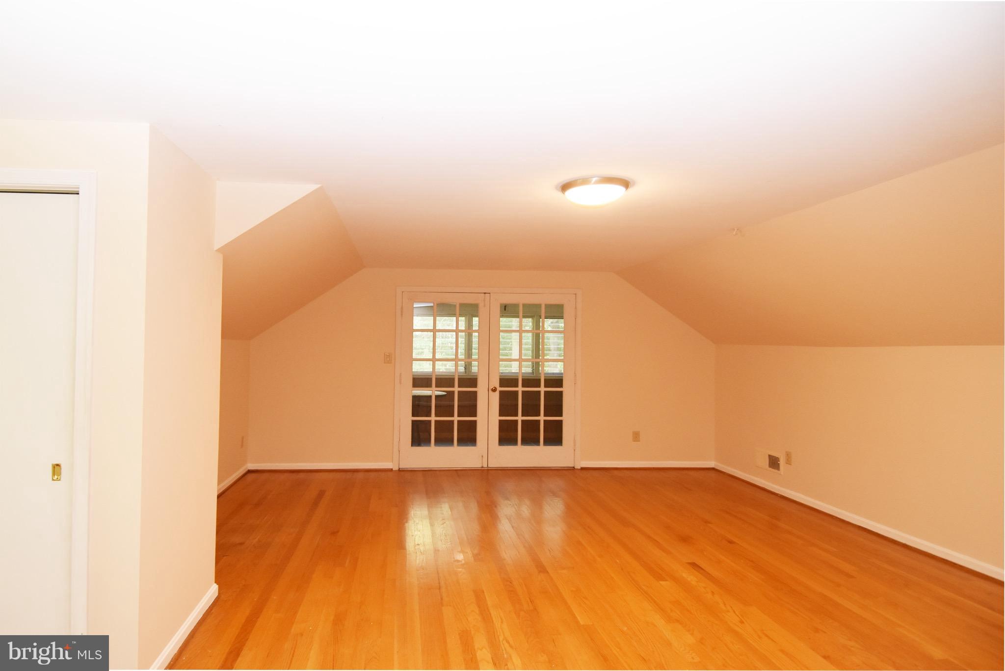 14911 West Auburn Road Accokeek, MD 20607 - Photo 20 of 30 an empty room with wooden floor and windows