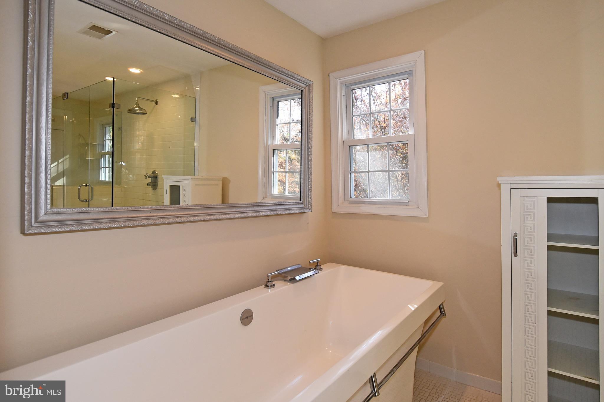 14911 West Auburn Road Accokeek, MD 20607 - Photo 25 of 30 a bathroom with a tub sink and mirror