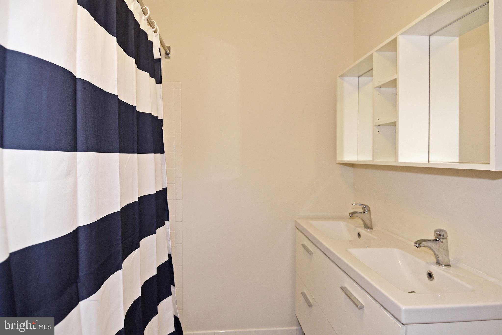 14911 West Auburn Road Accokeek, MD 20607 - Photo 27 of 30 a bathroom with a sink and a bathtub