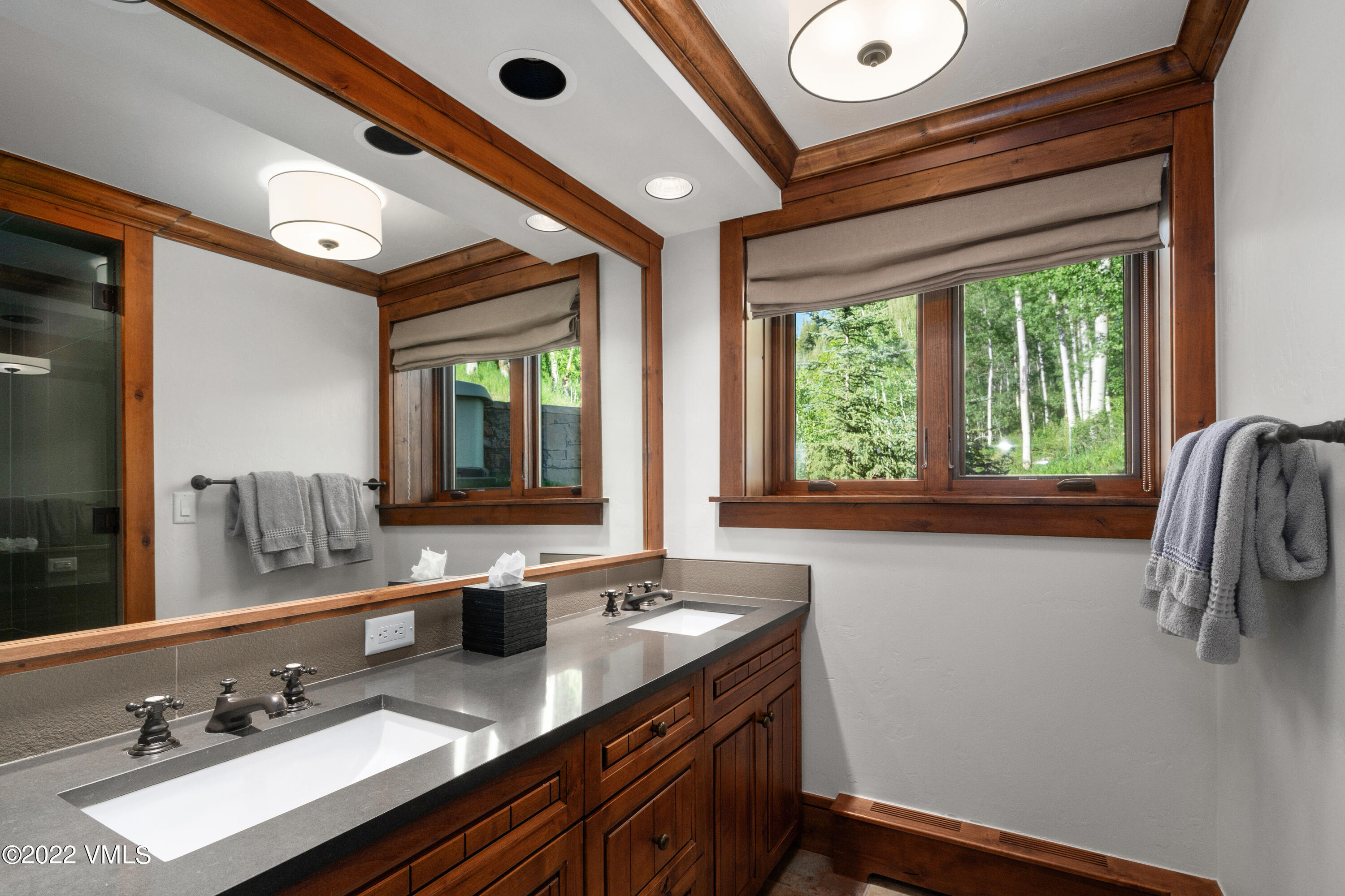 1250 Westhaven Circle Vail, CO 81657 - Photo 41 of 53 a bathroom with a double vanity sink a large mirror and a window