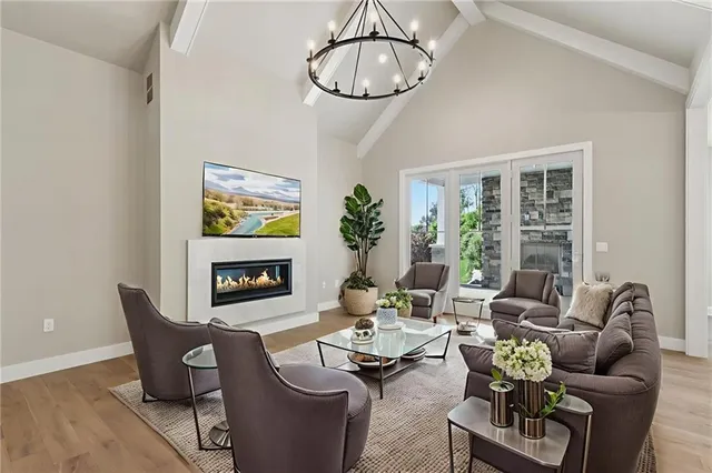 a living room with furniture a dining table and a fireplace