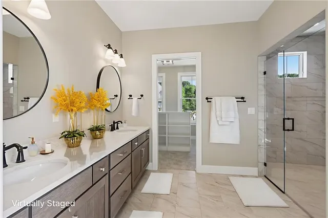 a bathroom with a double vanity sink mirror and shower