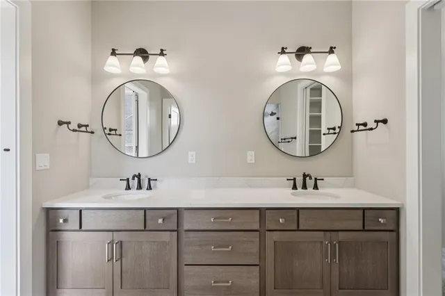 a bathroom with a double vanity sink and a mirror