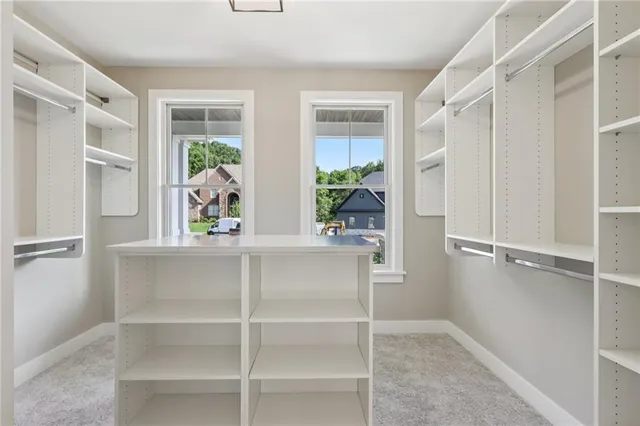 a view of walk in closet with empty racks