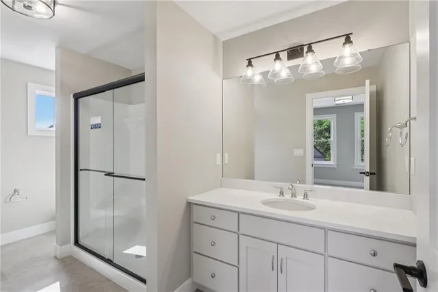a bathroom with a shower sink and mirror