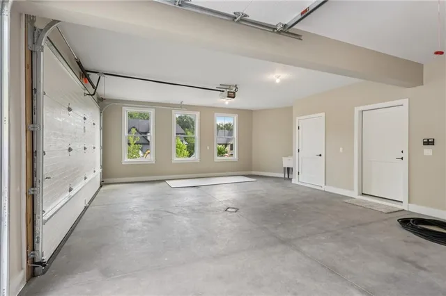 a porch with a table and chairs and potted plants