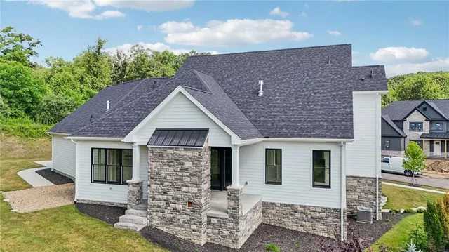 an aerial view of residential house with outdoor space and trees