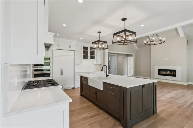 a large white kitchen with a stove and a refrigerator