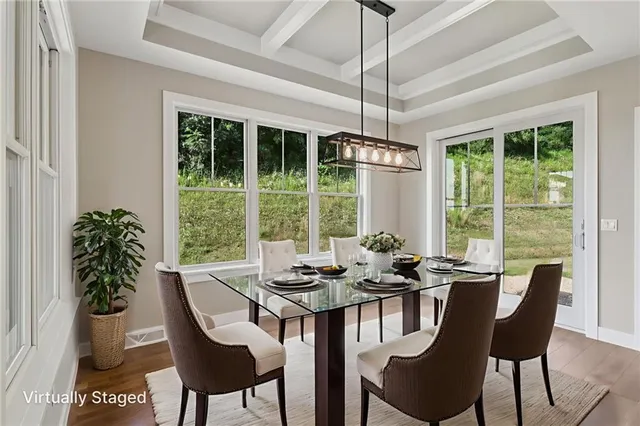 a dining room with furniture large windows and a chandelier