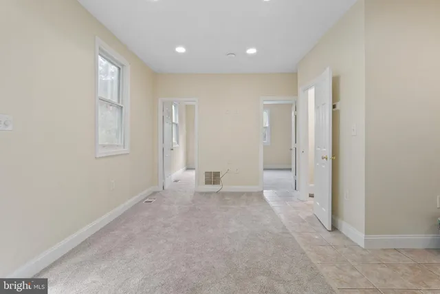 an empty room with windows and closet